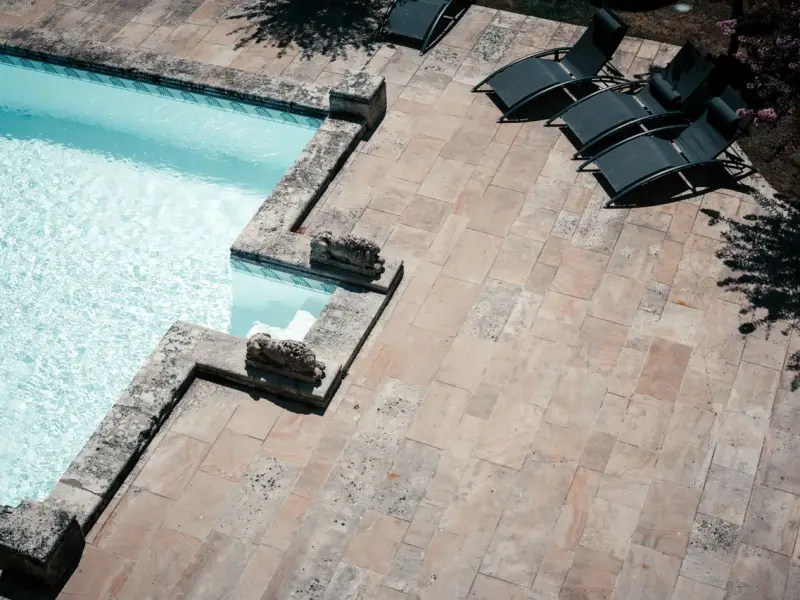 Terrasse et margelles de piscine en pierre naturelle nettoyées au karcher dans les Pyrénées-Orientales